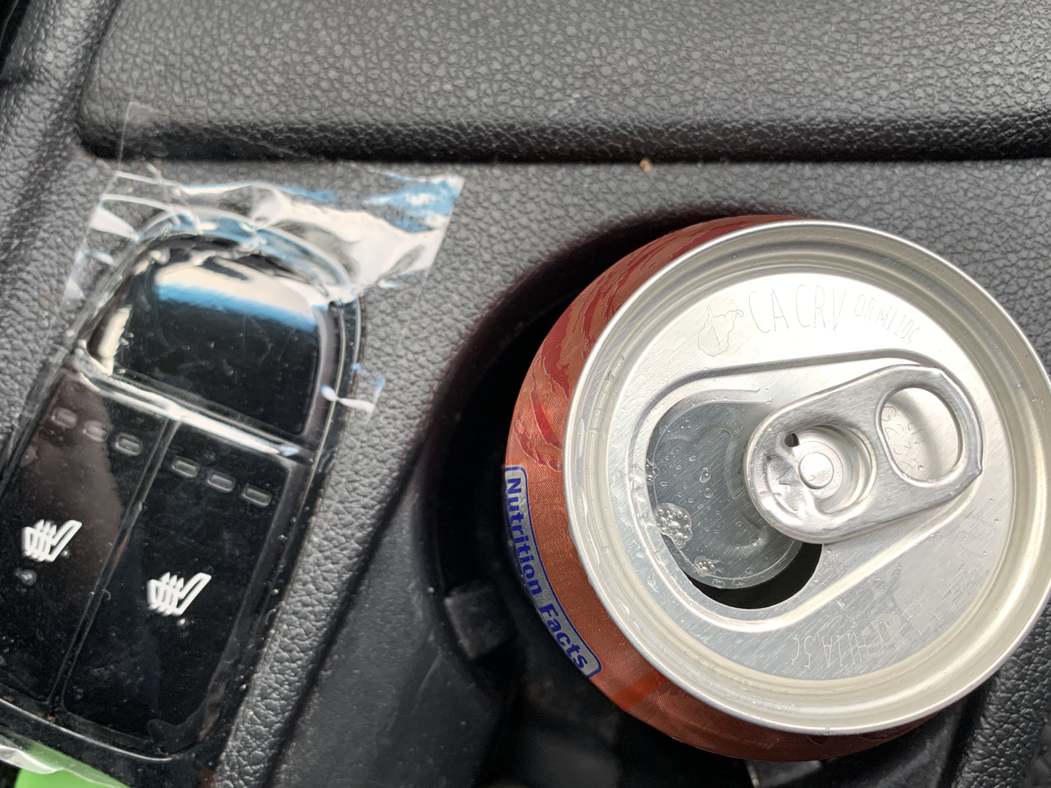 Kia Seat Heater Buttons Next to a Can of Soda